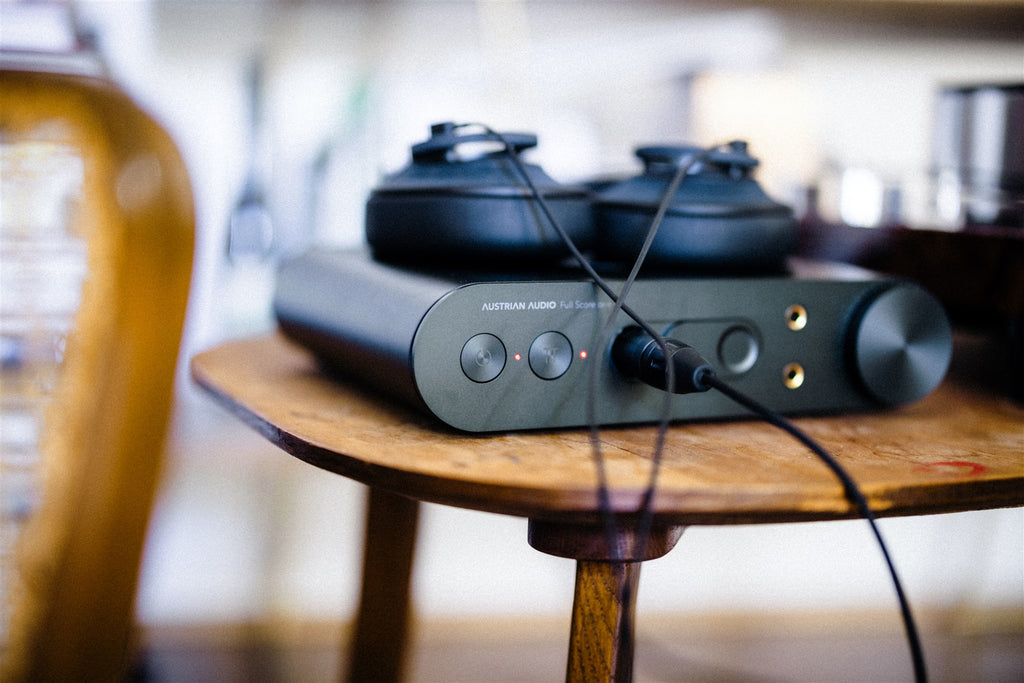Austrian Audio Full Score One headphone amplifier and DAC with sleek black finish and front panel controls.