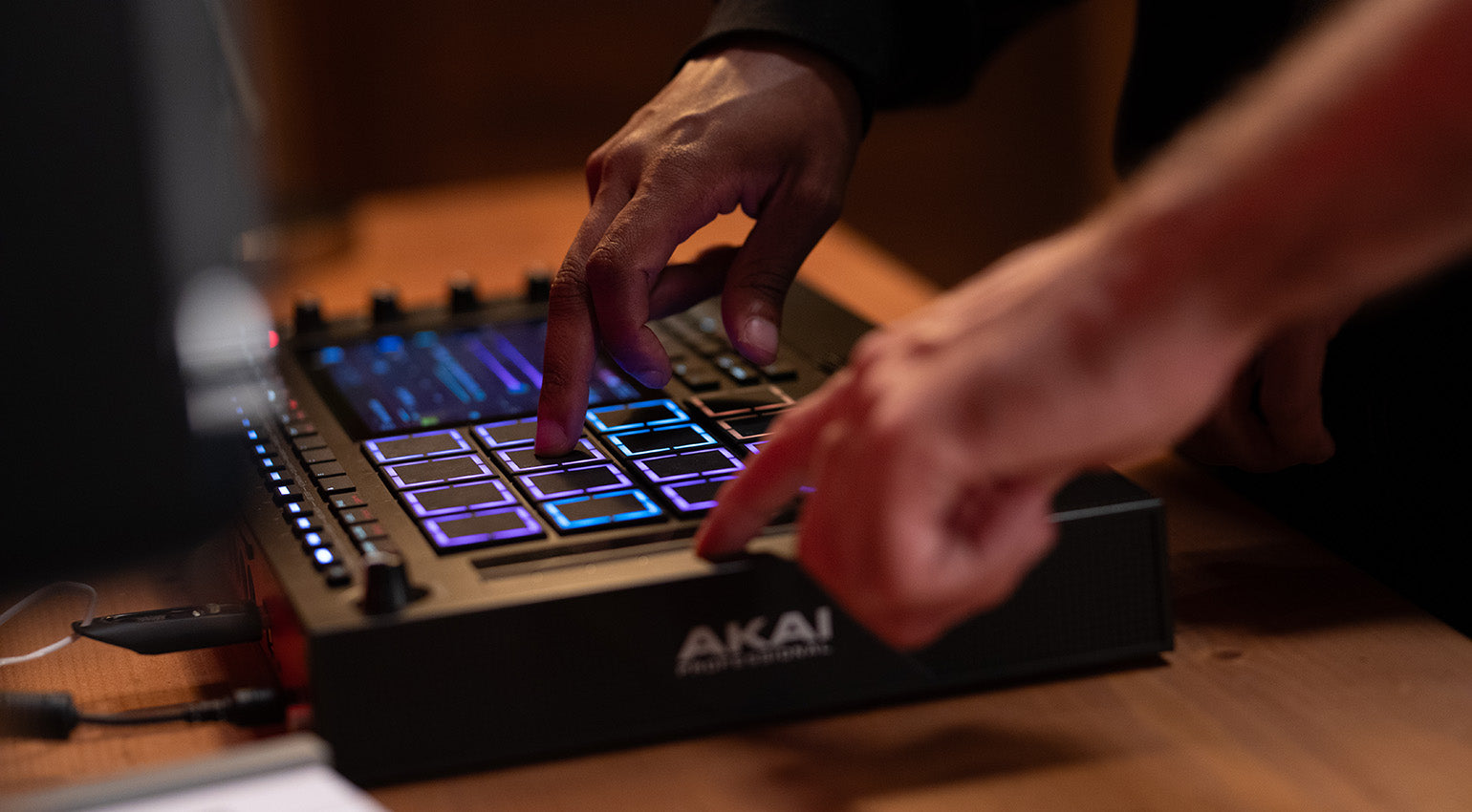 Akai Professional MPC Live III drum machine and sampler with colorful pad controls and touchscreen interface.