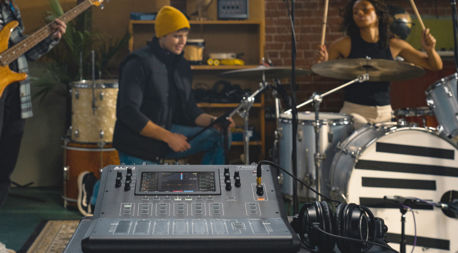 Alto Professional TMD16 digital mixer with multiple channels, knobs, and input/output ports on a professional audio equipment setup.