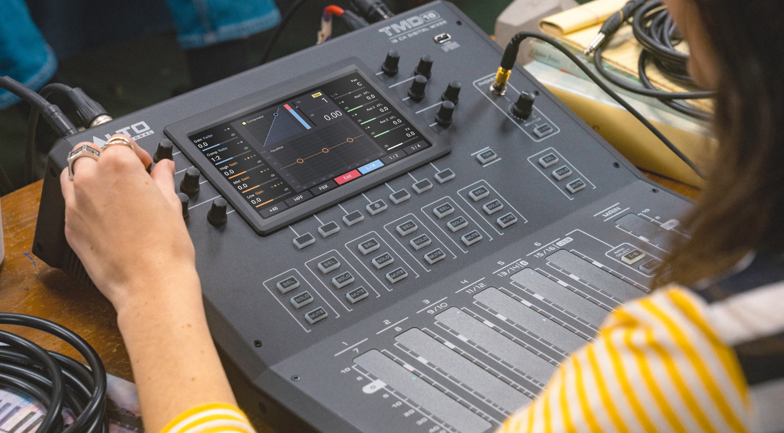 Alto Professional TMD16 digital mixer with multiple input channels and control knobs, ideal for live sound and recording setups.