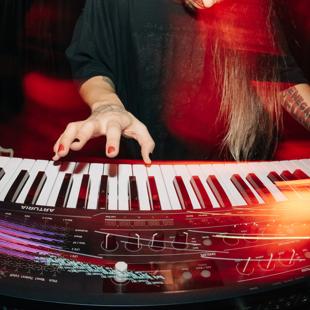 Musician playing the Arturia MiniFreak 49 full-size semi-weighted keyboard