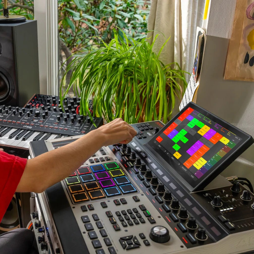 Akai Professional MPC XL drum machine and sampler with large pads, control knobs, and display screen for music production.