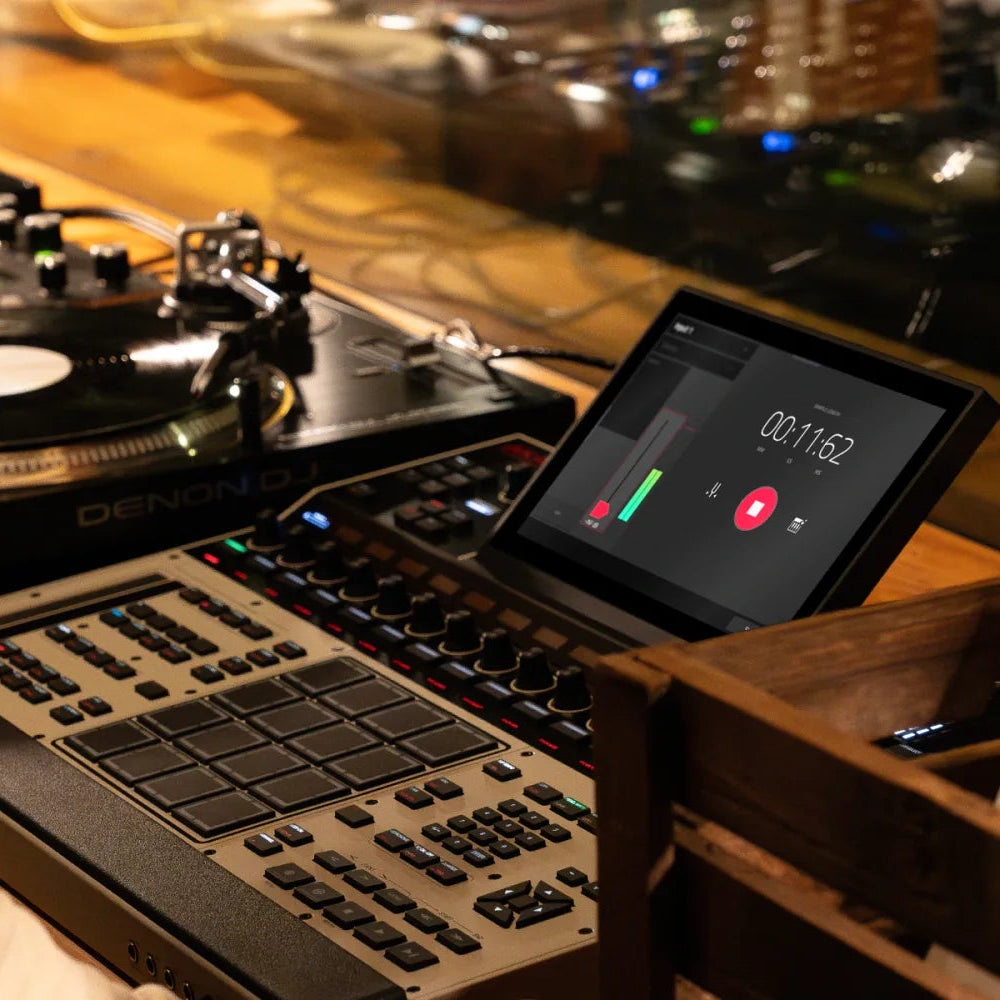 Akai Professional MPC XL drum machine and sampler with large grid of pads, control knobs, and screen for music production.