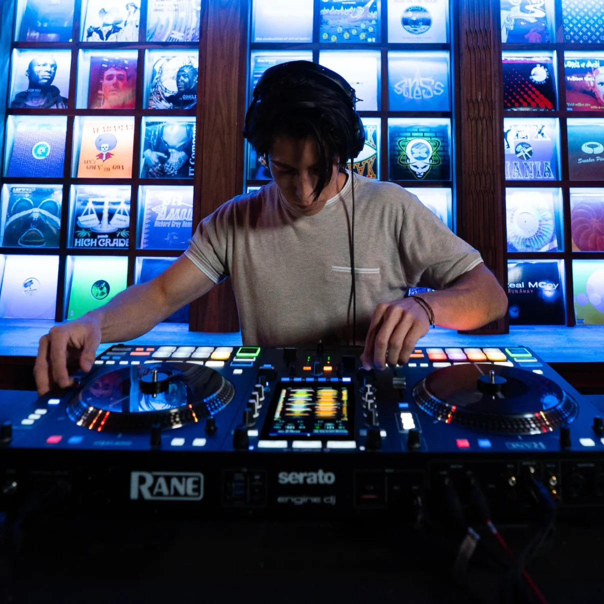 Rane System One DJ controller with jog wheels, mixer knobs, and performance pads for professional DJ mixing.