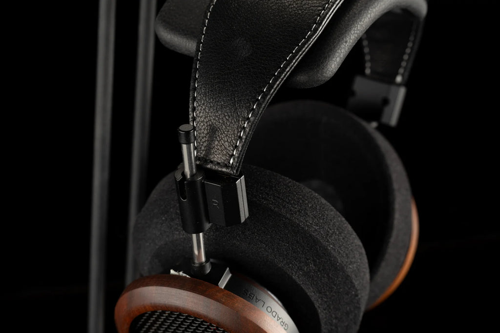 Grado Signature S950 wired headphones with over-ear design, silver finish, and adjustable headband, showing detailed ear cups and cables.