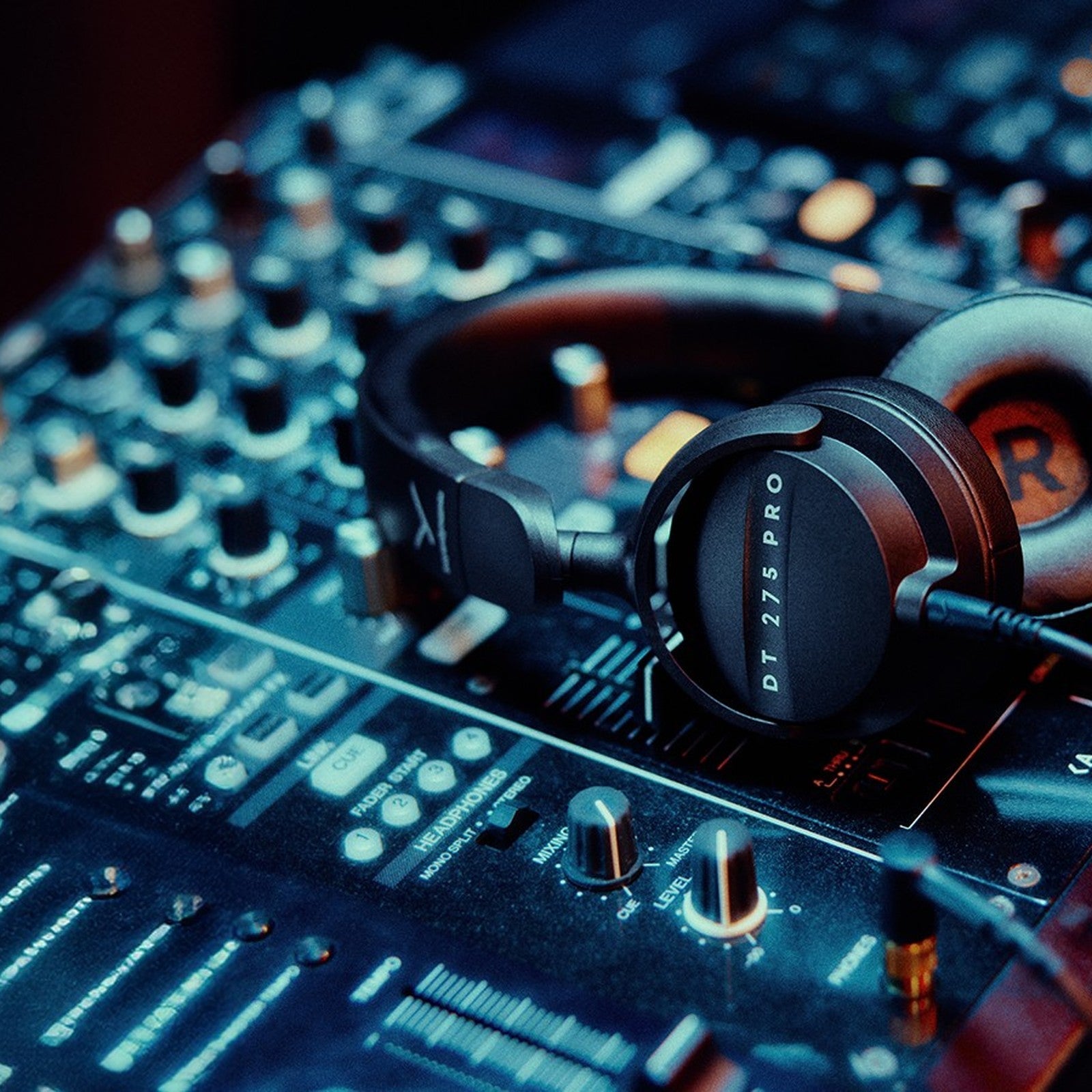 Beyerdynamic DT 275 PRO on-ear monitoring headphones resting on a DJ mixer