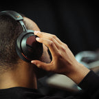 Gamer adjusting the Beyerdynamic MMX 130 Wireless headset in a gaming room