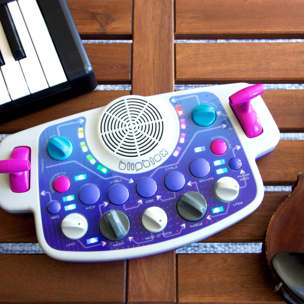 Blipblox SK2 on a table beside a MIDI keyboard