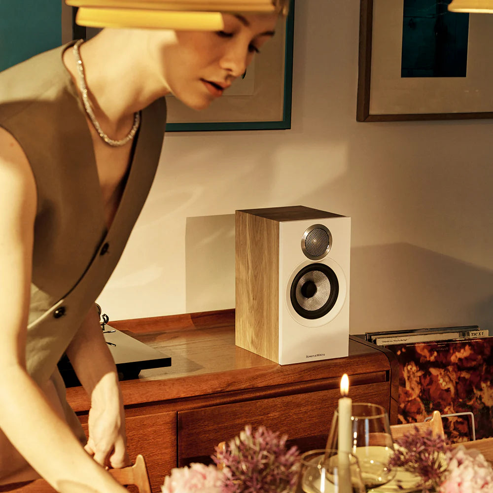 Bowers & Wilkins 607 S3 passive bookshelf speakers shown in a stylish living room setup with wood finish and modern decor.