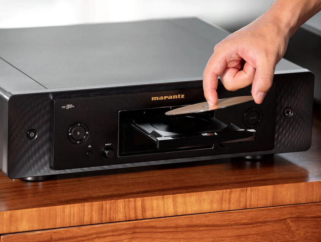 Marantz CD 50n portable music player with a sleek design and digital display, shown in a collage image.