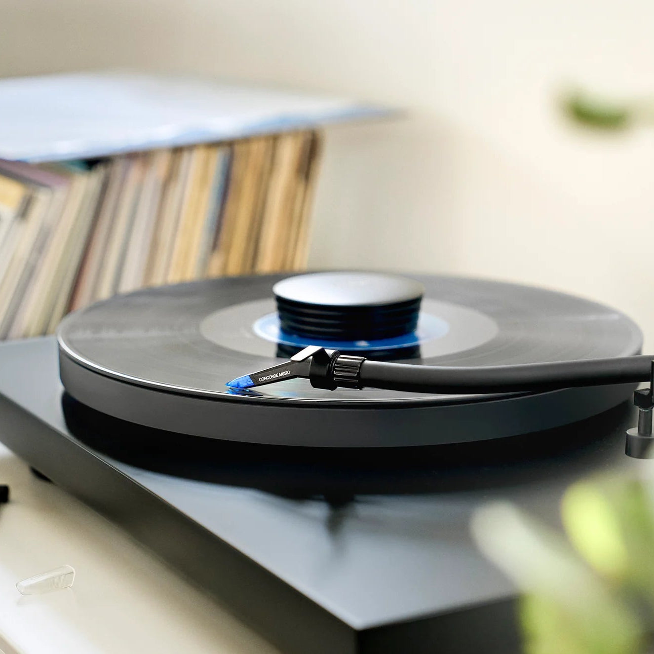 Ortofon Concorde Music Blue turntable cartridge mounted on a Pro-Ject turntable, close-up view of the cartridge and tonearm.