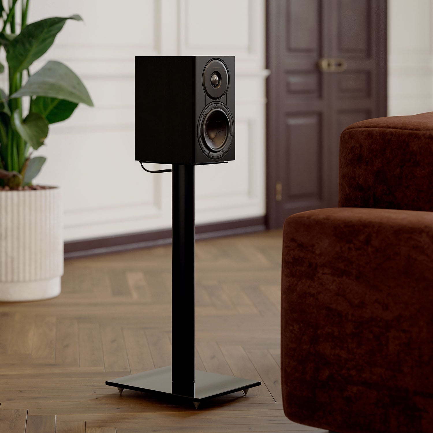 DALI Sonik 1 passive bookshelf speakers with black wood finish, showcasing sleek design and front grille in the image.