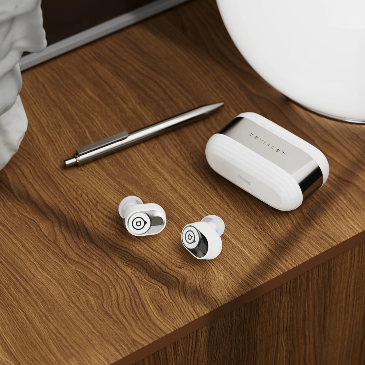 Devialet Gemini II wireless in-ear headphones, white earbuds and case lifestyle