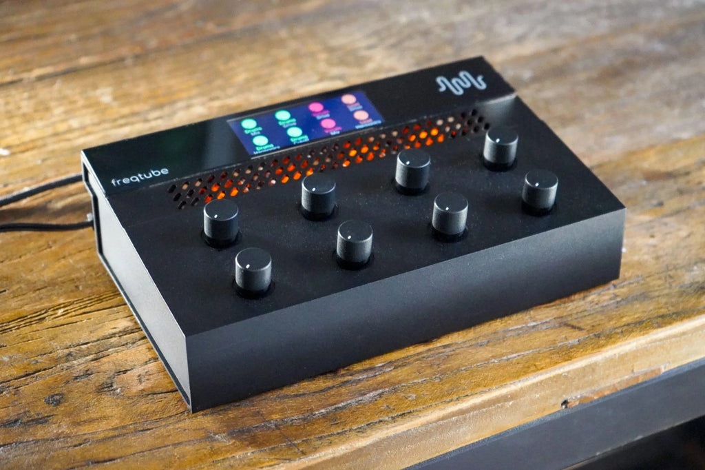 Freqport FreqTube FT1 effects pedal with control knobs and input/output jacks, designed for guitar and audio effects.