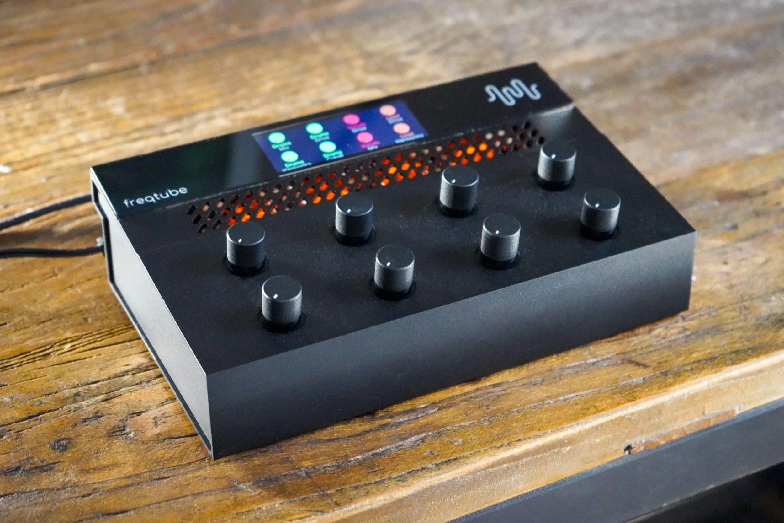 Freqport FreqTube FT1 effects pedal with control knobs and input/output jacks, designed for guitar and audio effects.