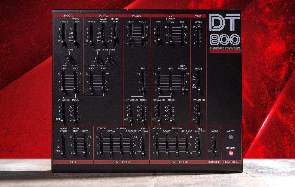 Dtronics DT-800 synthesizer with multiple knobs and controls, featuring a sleek black design and digital display.