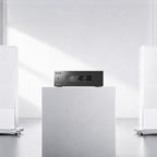 Eversolo AMP-F8 on a white plinth between white floorstanding speakers