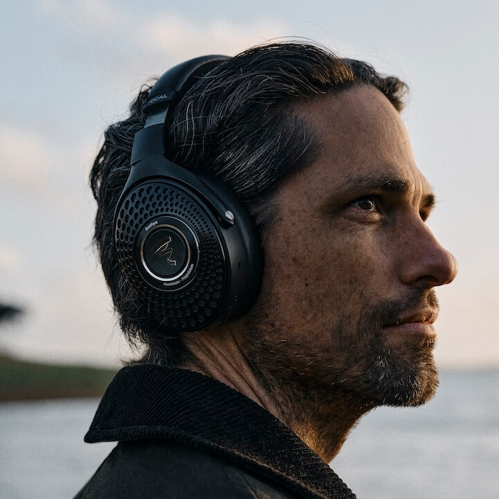 Focal Bathys wireless headphones worn by a man in a black color, showcasing sleek design and comfortable fit.