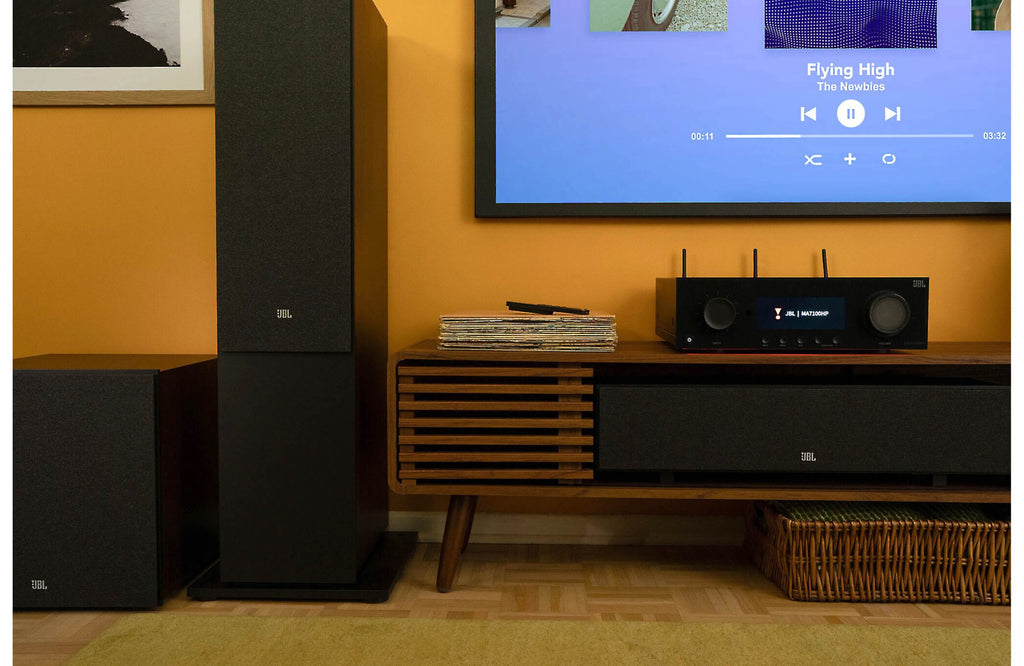 JBL MA7100HP stereo amplifier with black metal casing and control knobs, designed for high-quality audio amplification.
