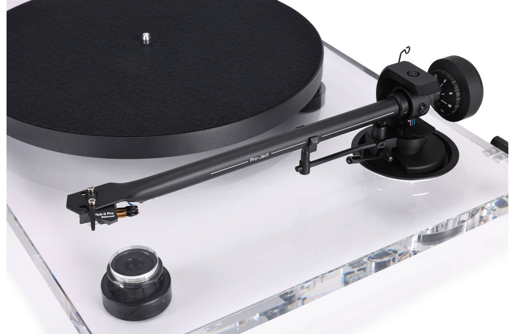 Pro-Ject XA B turntable with wooden plinth and tonearm, showcasing its sleek design and high-quality audio setup.