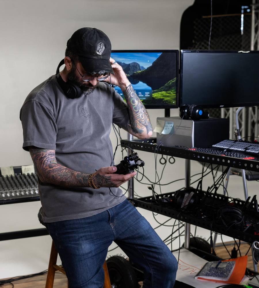 Zoom H5 digital audio recorder with RF interference pattern displayed on its screen, showcasing professional recording capabilities.