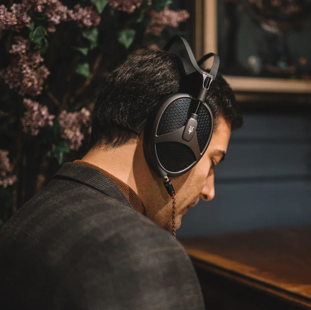Meze Audio Elite Tungsten wired headphones with sleek design and cushioned ear cups, shown from a side angle.
