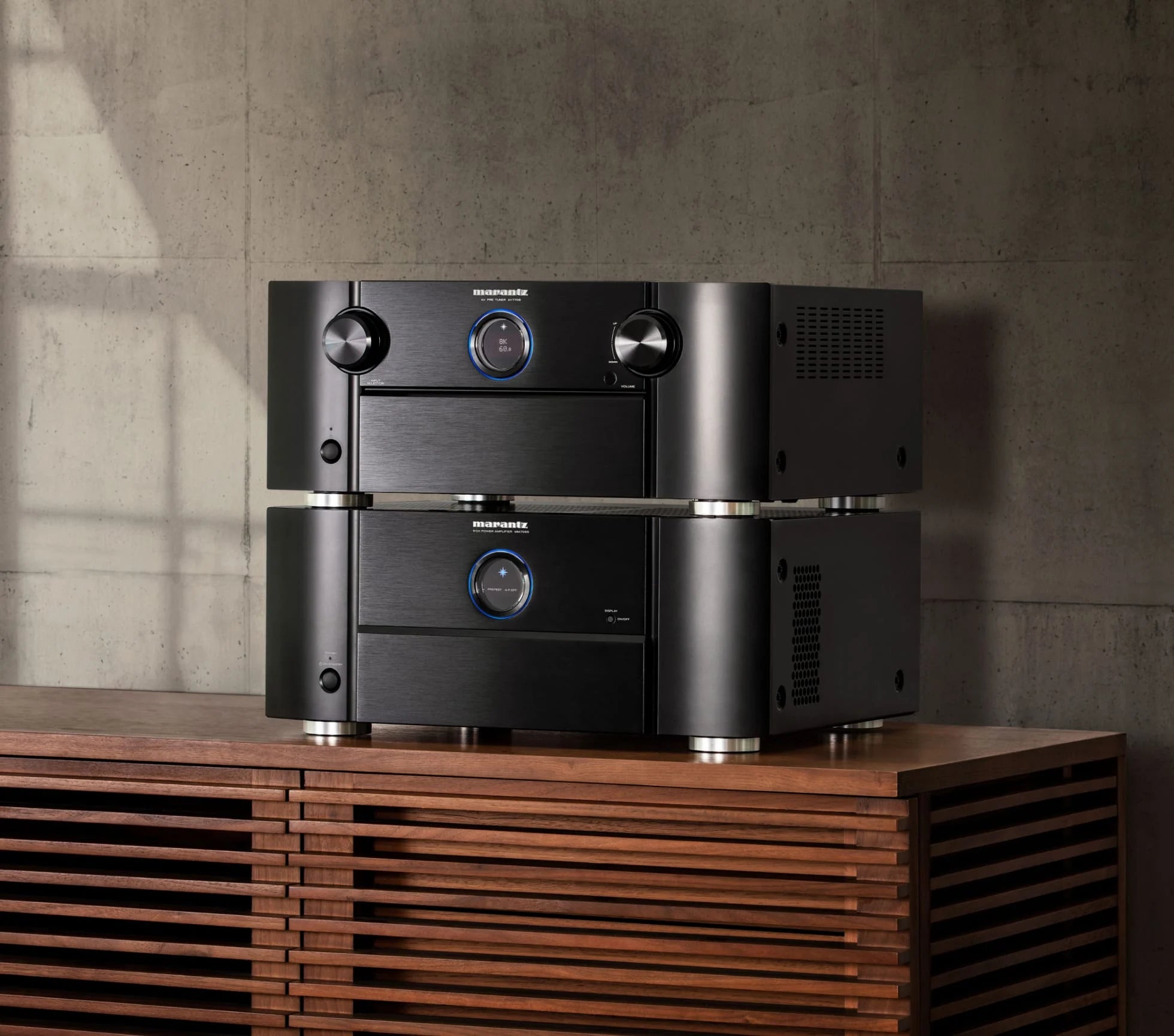 Marantz MM7055 stereo amplifier in black, showcasing front panel with multiple control knobs and input options.
