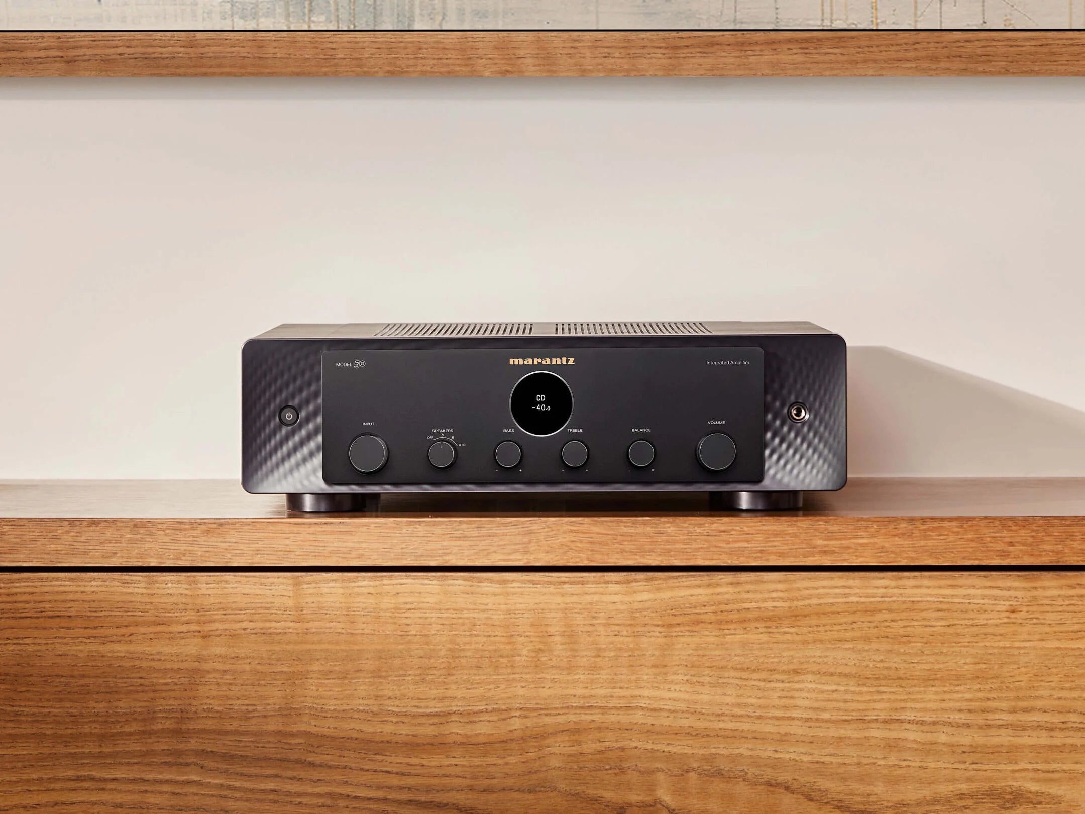Marantz MODEL 50 stereo amplifier in black with a sleek front panel and control knobs, studio elevated view.