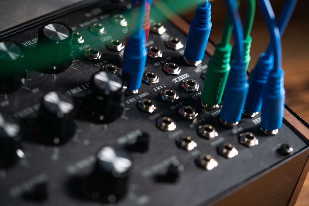 Close-up of Moog Labyrinth synthesizer showing detailed control knobs and vintage-inspired design elements.