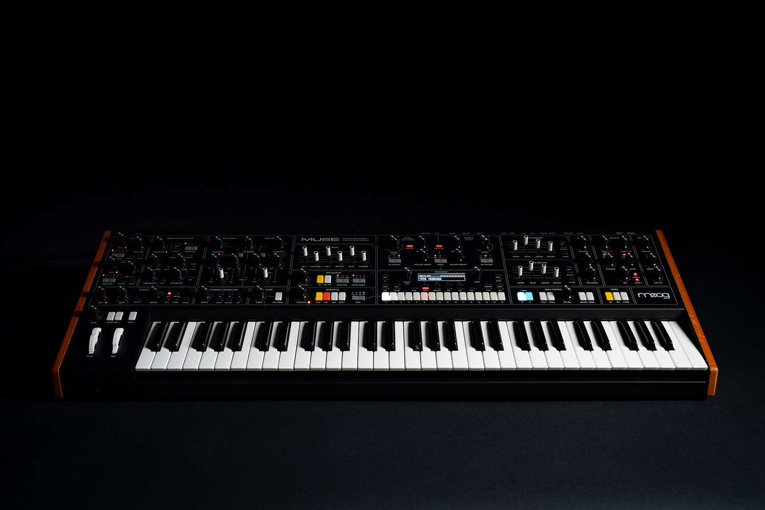 Moog Muse synthesizer with black background, featuring knobs, keys, and controls in a sleek electronic music instrument design