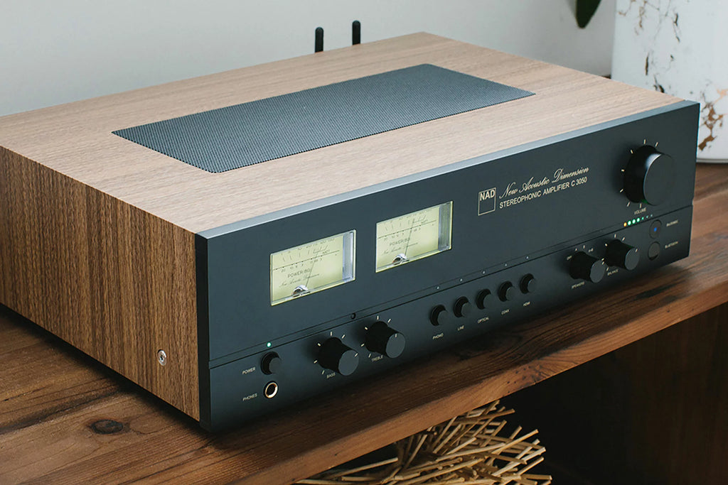 NAD C 3050 stereo amplifier shown from an angled view, showcasing its sleek design and control knobs for high-quality audio.