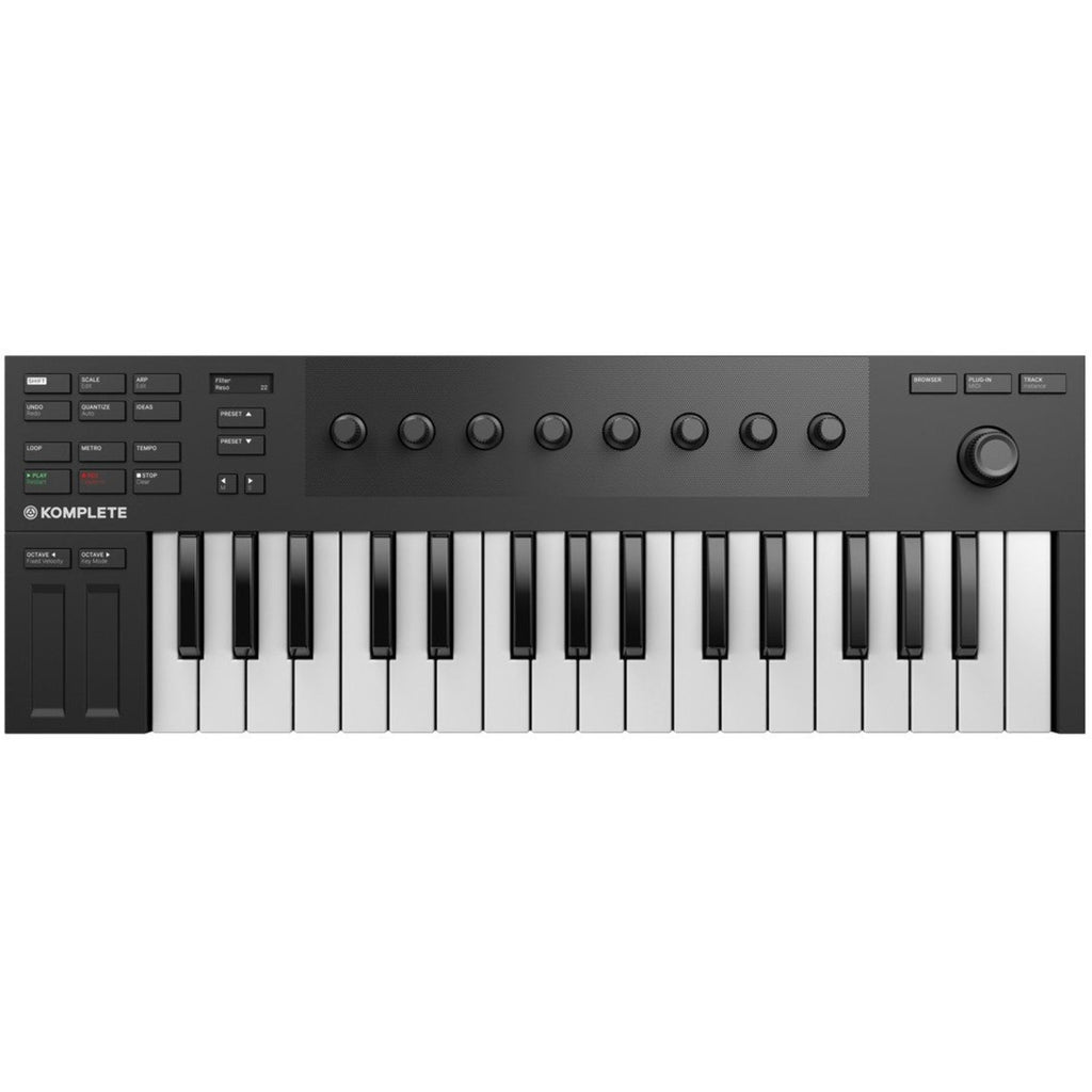 Native Instruments Komplete Kontrol M32 MIDI keyboard with 32 keys and control knobs, shown on a music studio desk.