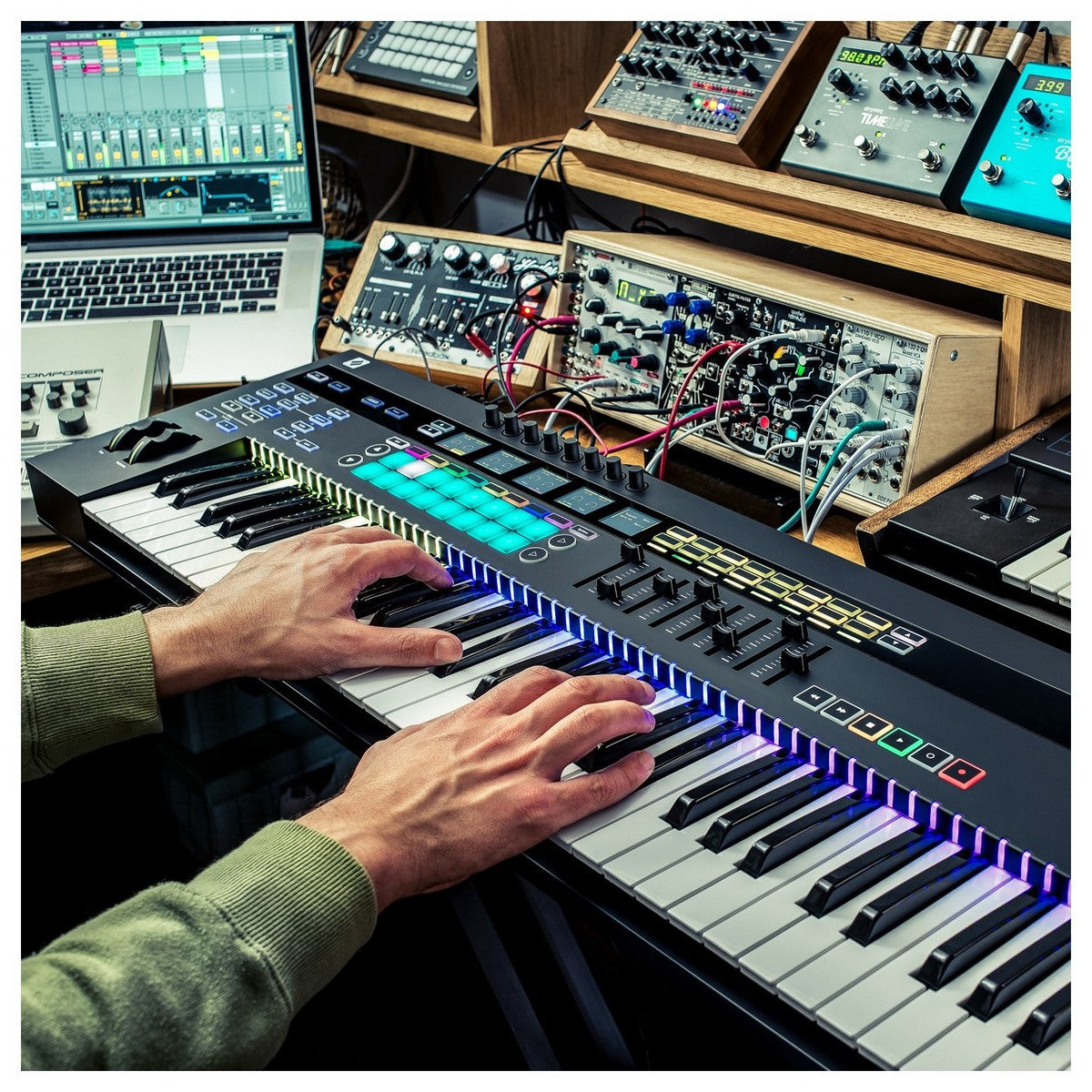 Novation 61SL MK3 MIDI keyboard with 61 keys, control knobs, and pitch/mod wheels, showing front view of the Novation MIDI controller.
