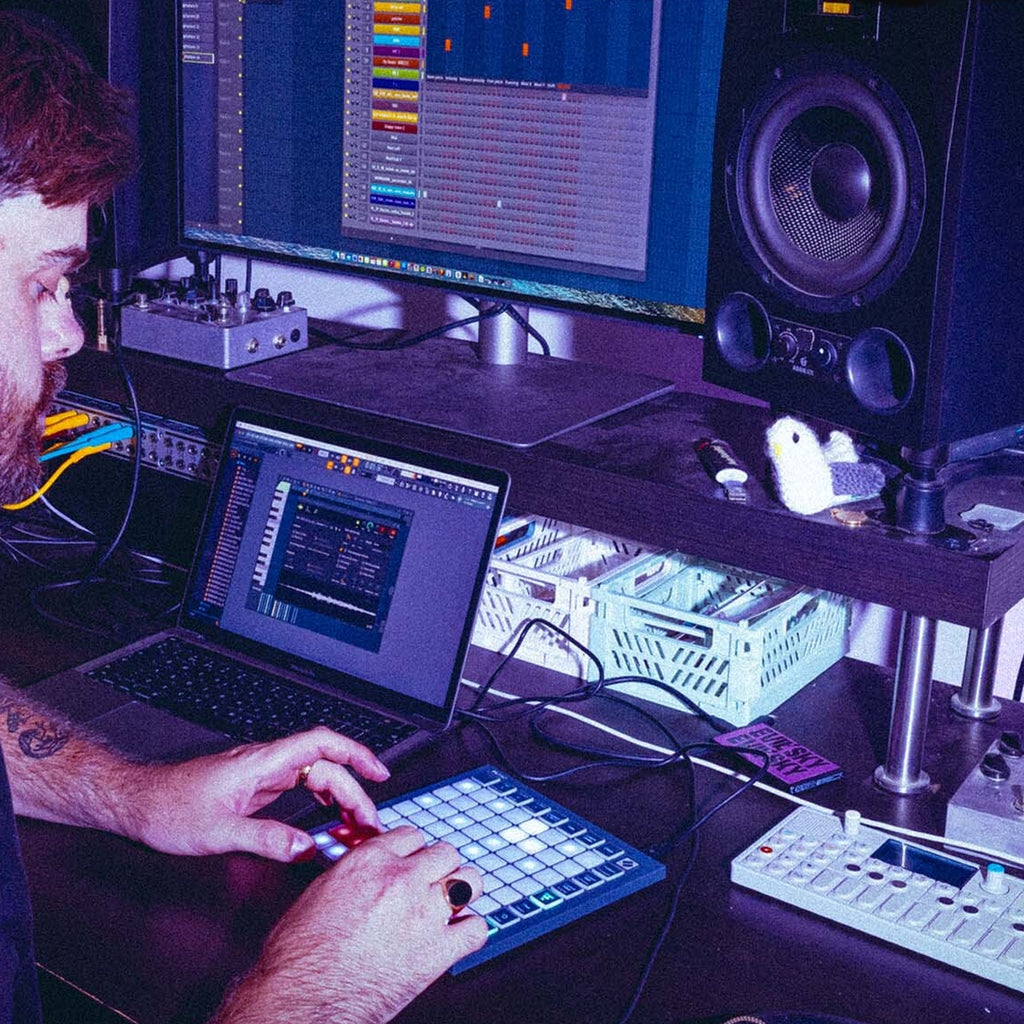Novation FLpad Mini, on a producer desk with a laptop and drum machine
