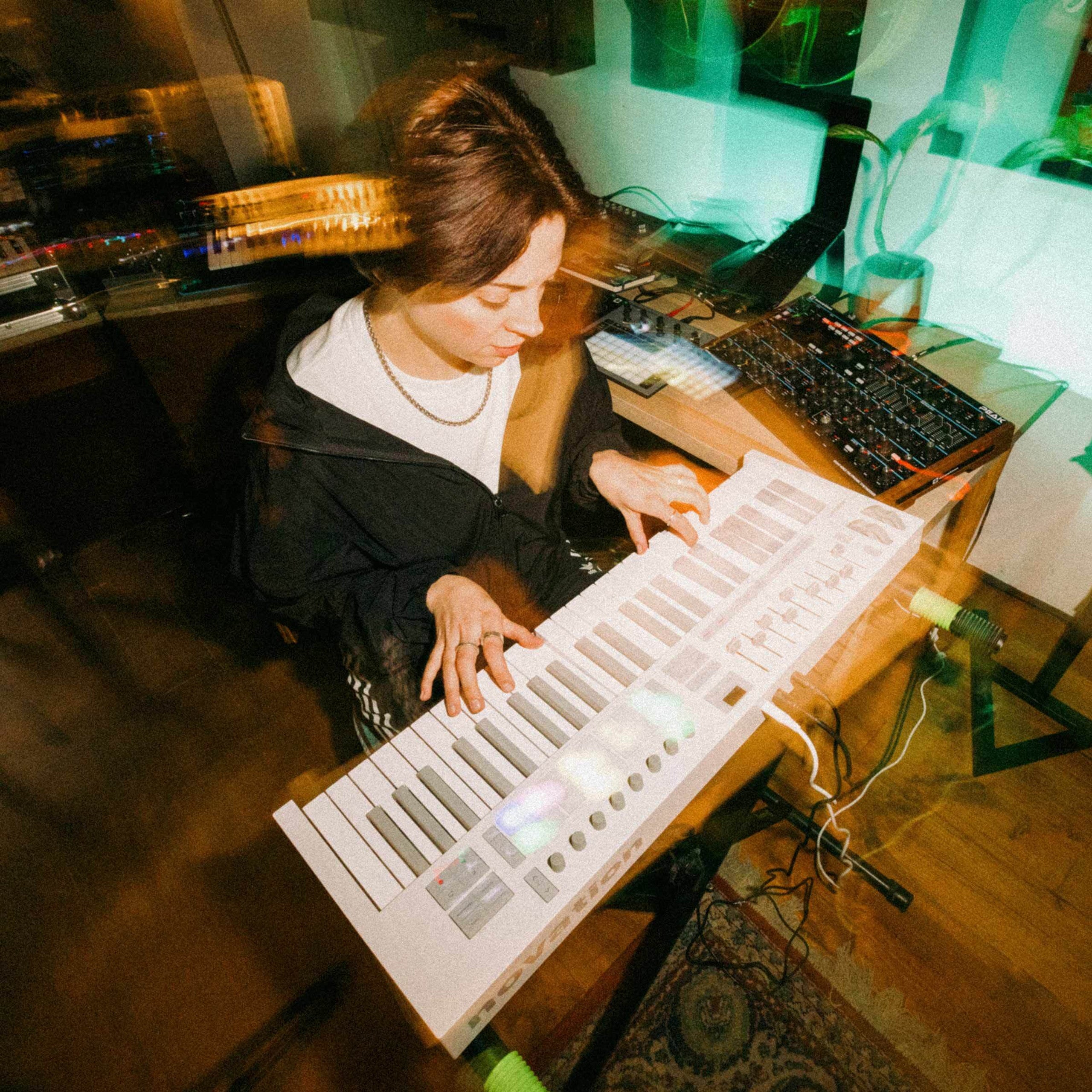 Novation Launchkey 49 MK4 MIDI keyboard, in white, lifestyle setting