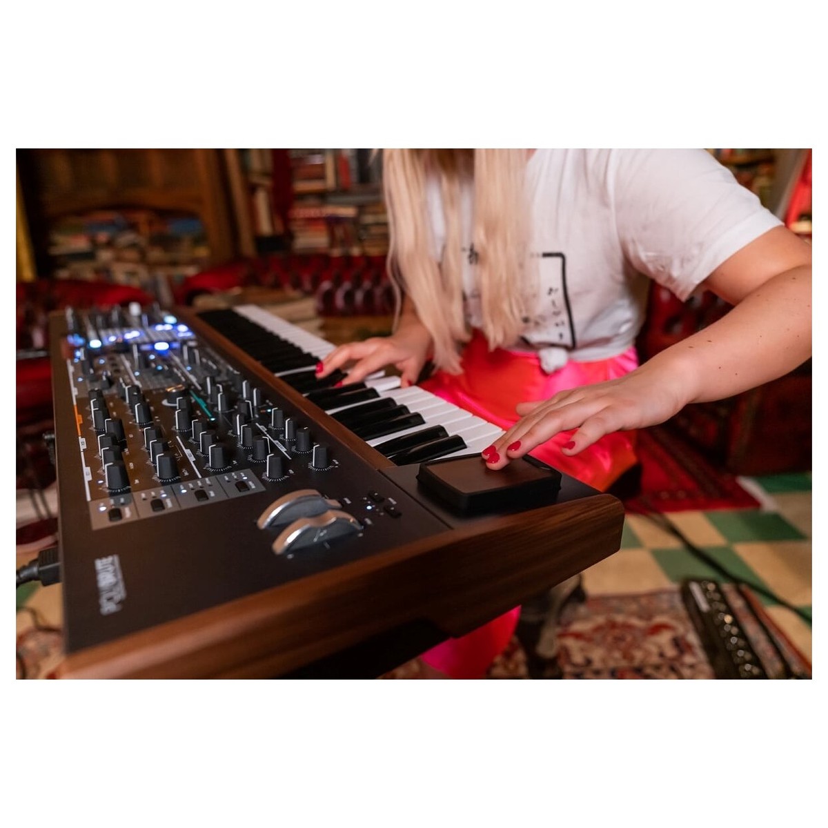 Arturia PolyBrute synthesizer with multiple knobs and sliders, showcasing its sleek black design and advanced control panel.