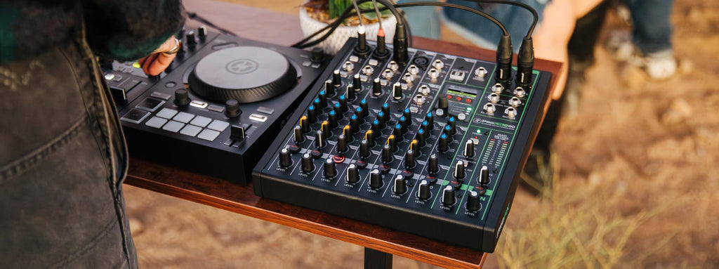 Mackie ProFX10 GO analog mixer with multiple input channels, knobs, and faders on a clean desktop setup.
