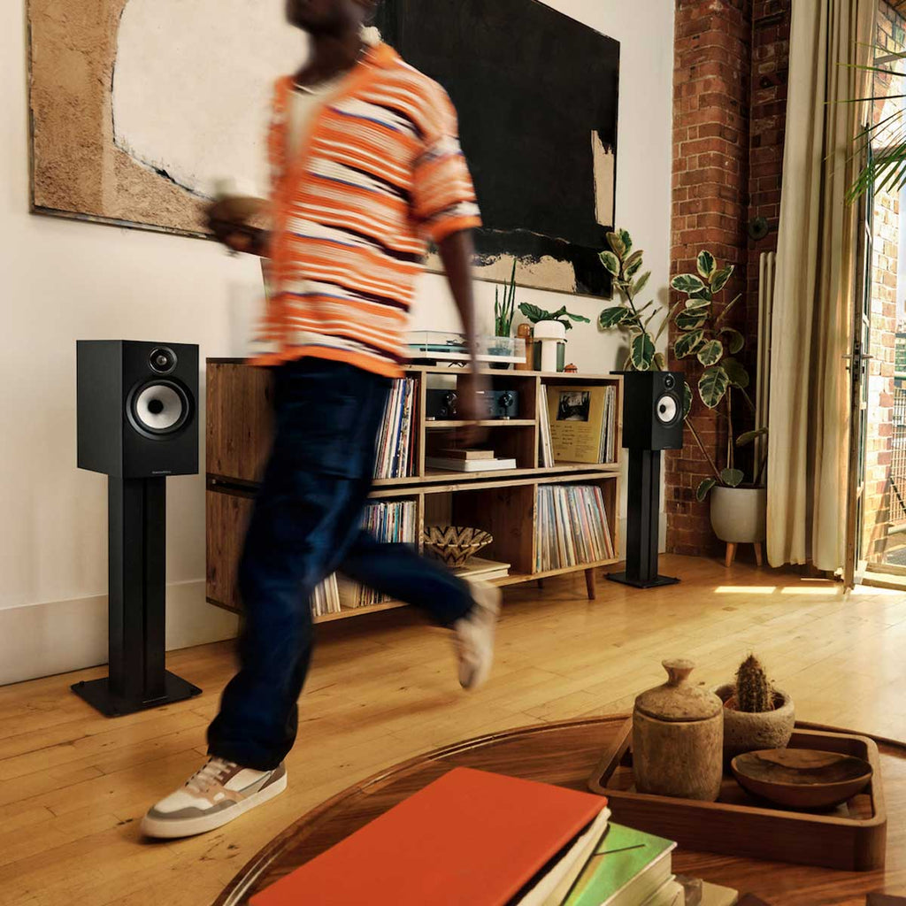 Bowers & Wilkins 606 S3 passive bookshelf speakers with black finish and modern design, placed on a wooden surface.