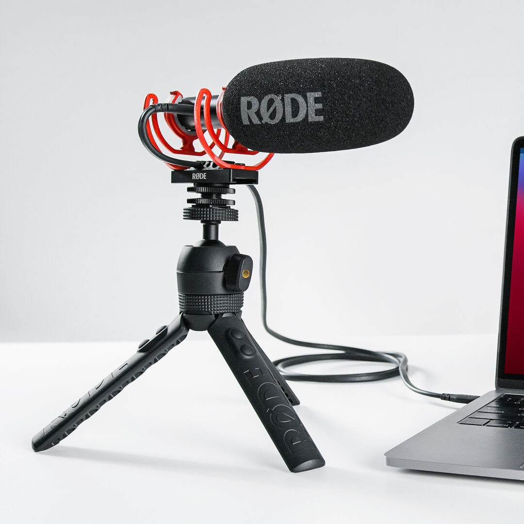 Rode VideoMic NTG camera microphone mounted on a tripod for professional audio recording and video production.