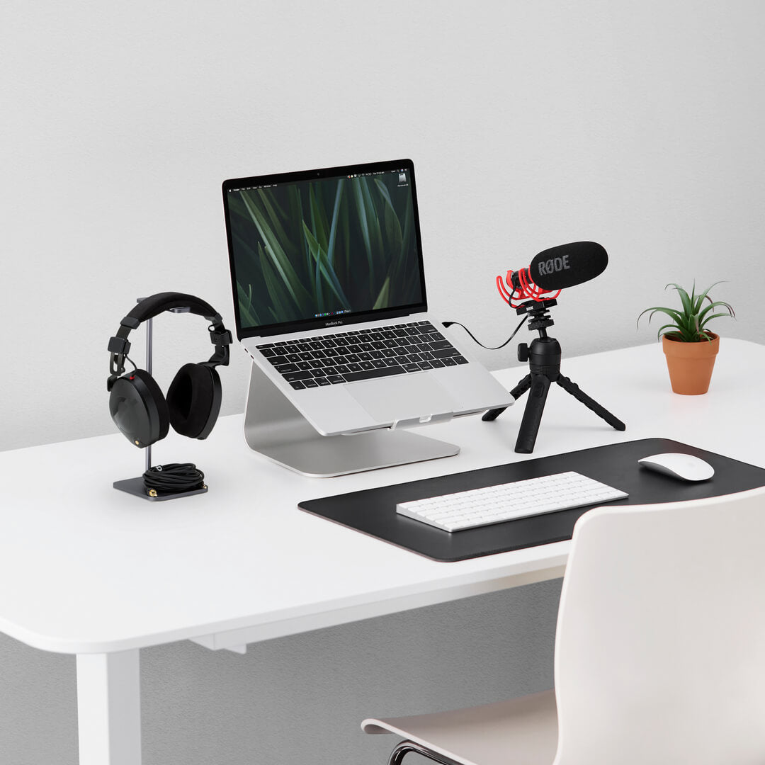 Rode VideoMic NTG camera microphone mounted on tripod, positioned on a clean desk with a blurred background.