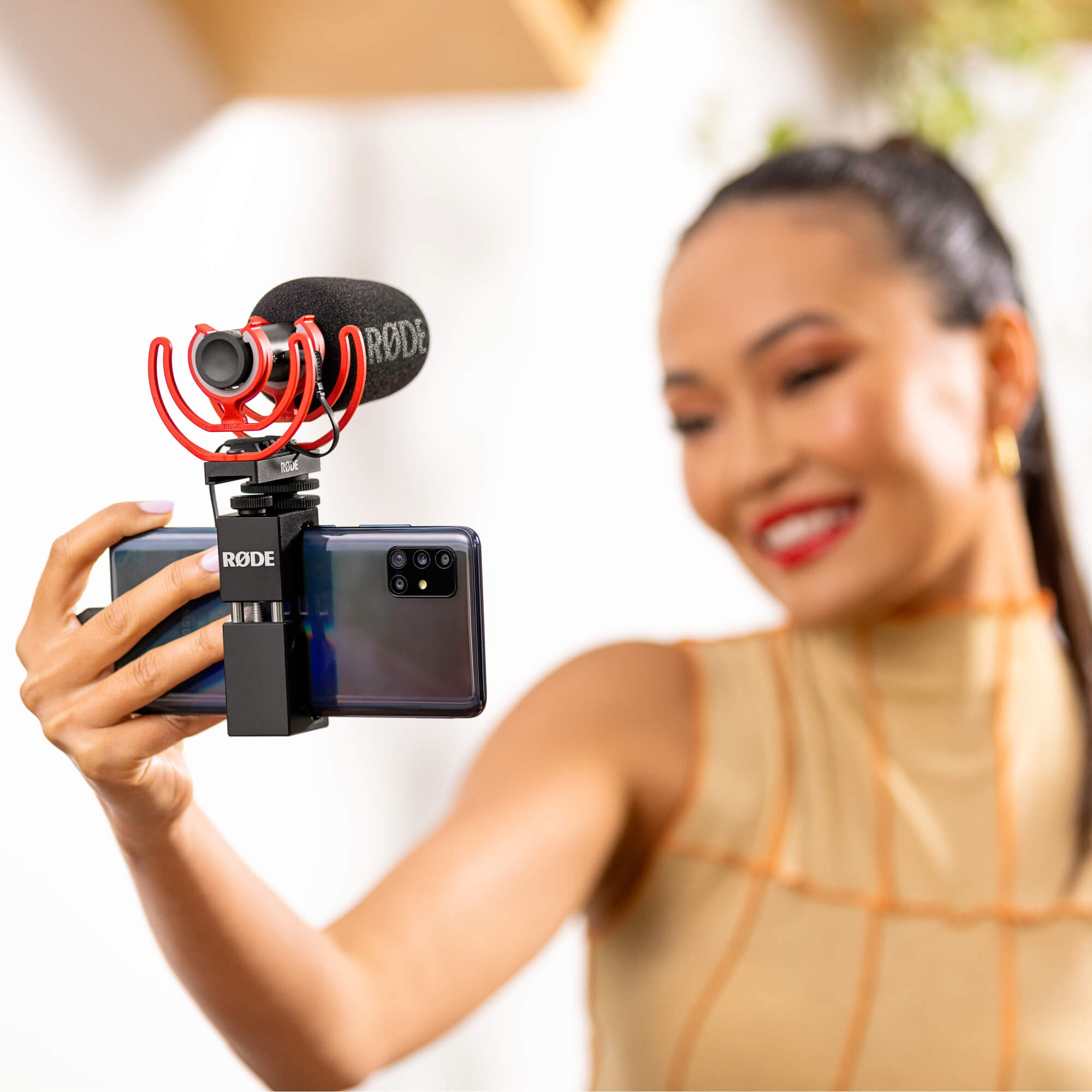 Rode SC16 USB C cable connected to a Rode VideoMic GO II on a mobile setup with a girl taking a selfie.