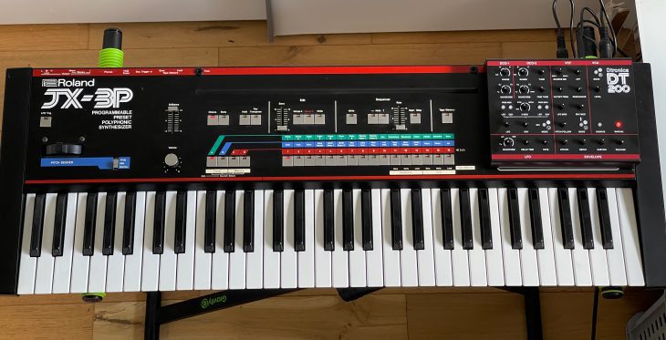 Dtronics DT-200 V3 synthesizer with Roland JX-3P setup, featuring control panel and vintage-style keyboard in a studio environment.