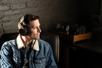 Wired Grado Signature S950 headphones with open-back design and premium wood ear cups, shown from a side angle.