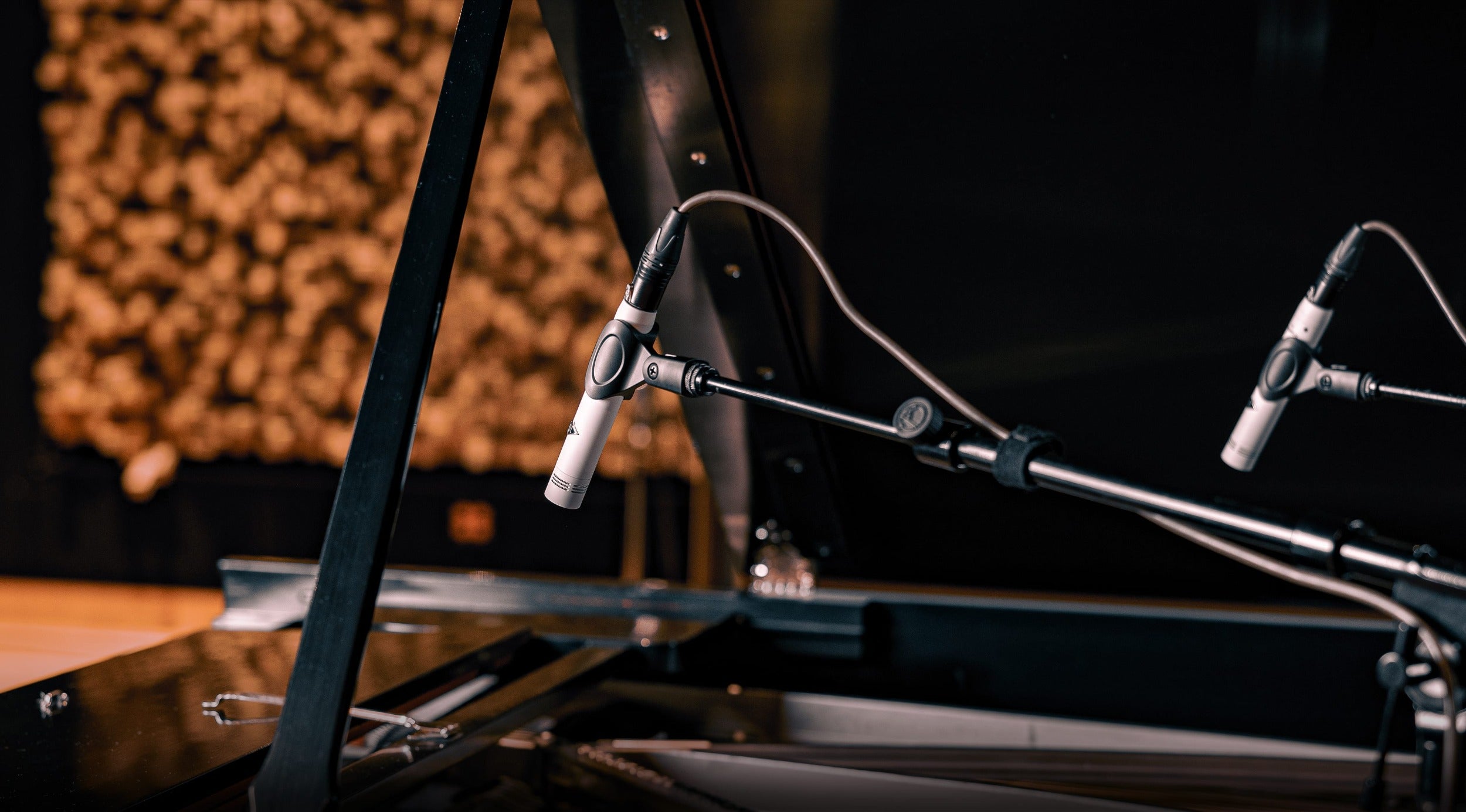 Universal Audio SP-1 condenser microphone with professional-grade design and adjustable stand, ideal for studio recording.