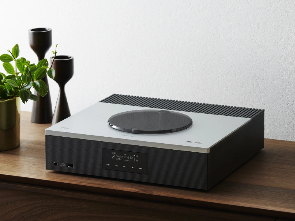 Technics SA-C600 stereo amplifier shown in a modern living room setup with sleek design and digital controls.