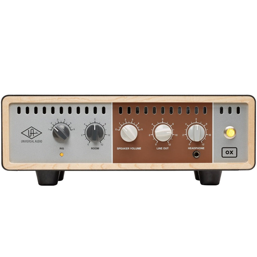 Universal Audio OX Amp Top Box shown with guitar amp and cable connections, compact device for guitar tone shaping.