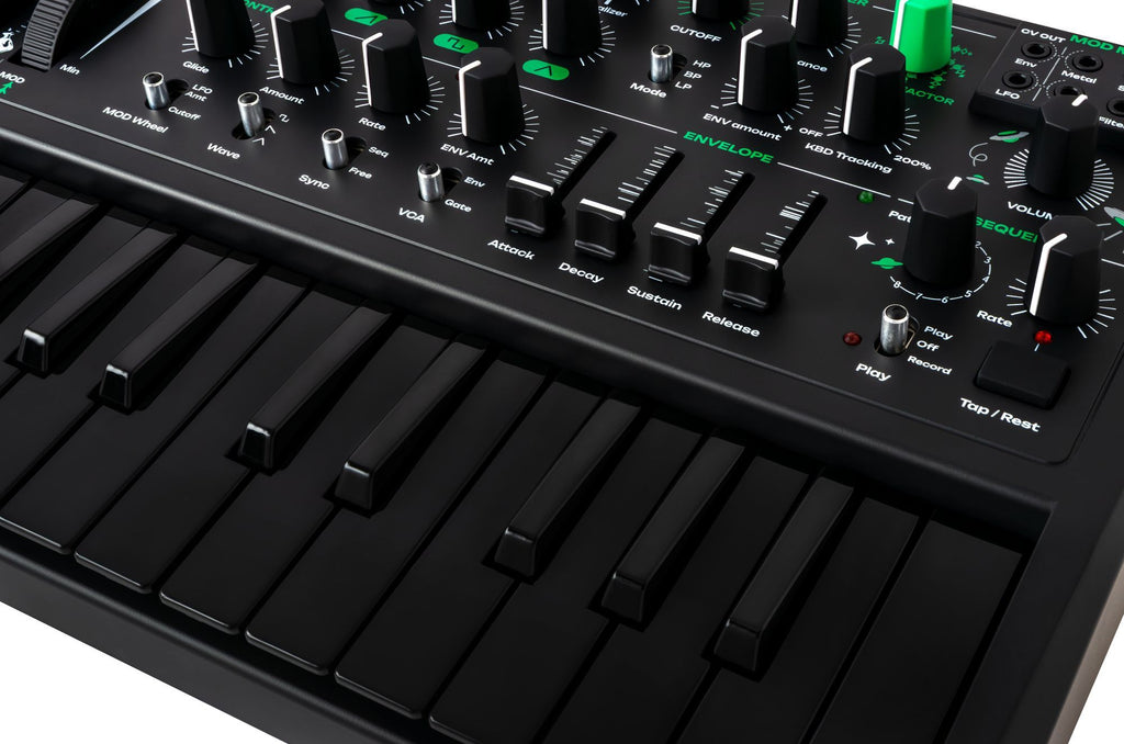 Close-up of the Arturia MicroBrute UFO keyboard synthesizer with detailed knobs and controls on a sleek black finish.