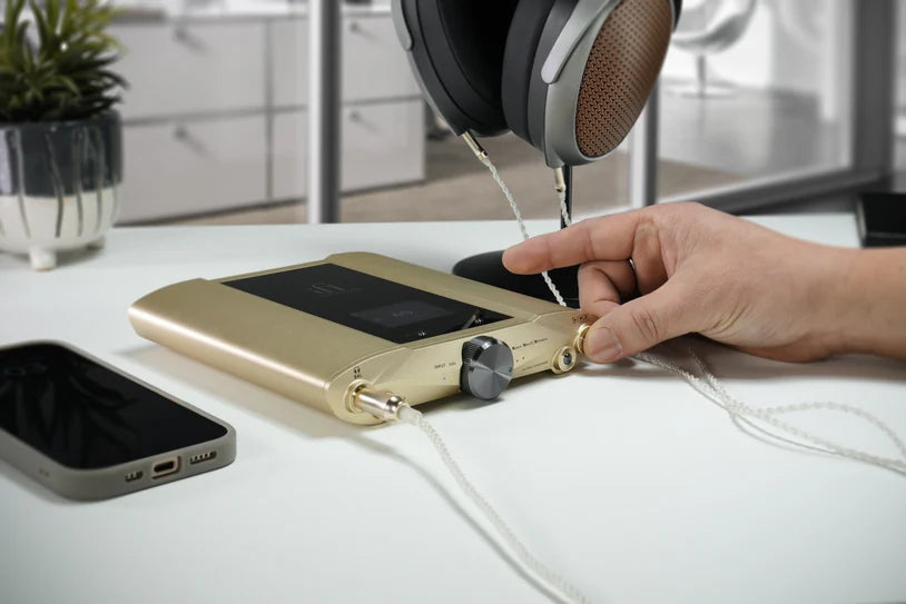 iFi Audio iDSD Valkyrie headphone amplifier and DAC with sleek design, shown in a lifestyle setting.