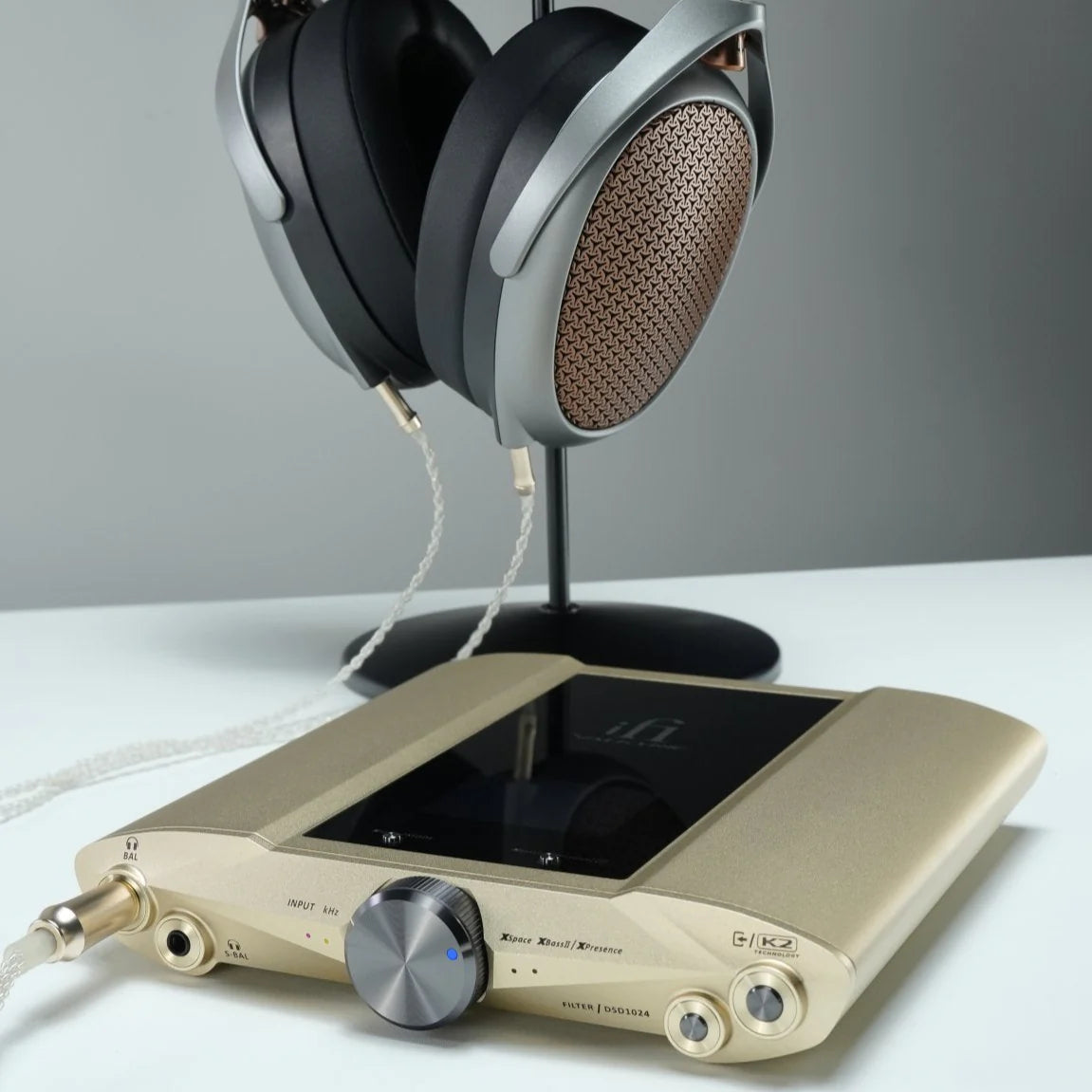iFi Audio iDSD Valkyrie headphone amplifier and DAC with sleek black design and various input ports, set on a modern desk.