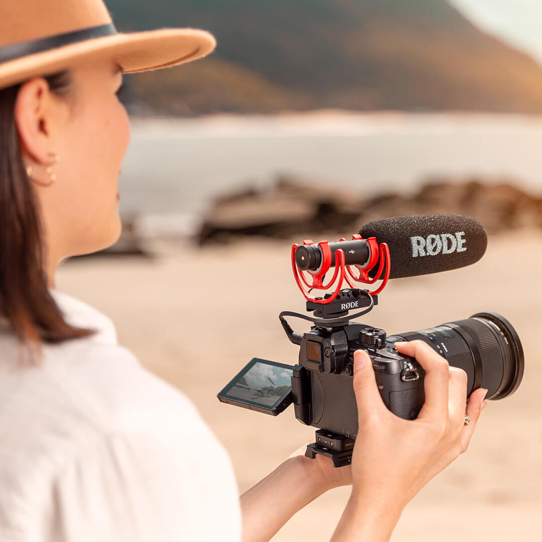 Rode VideoMic NTG camera microphone mounted on a camera, showing its compact design and built-in shock mount.